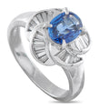 Platinum ring with blue oval sapphire center and diamond pinwheel halo