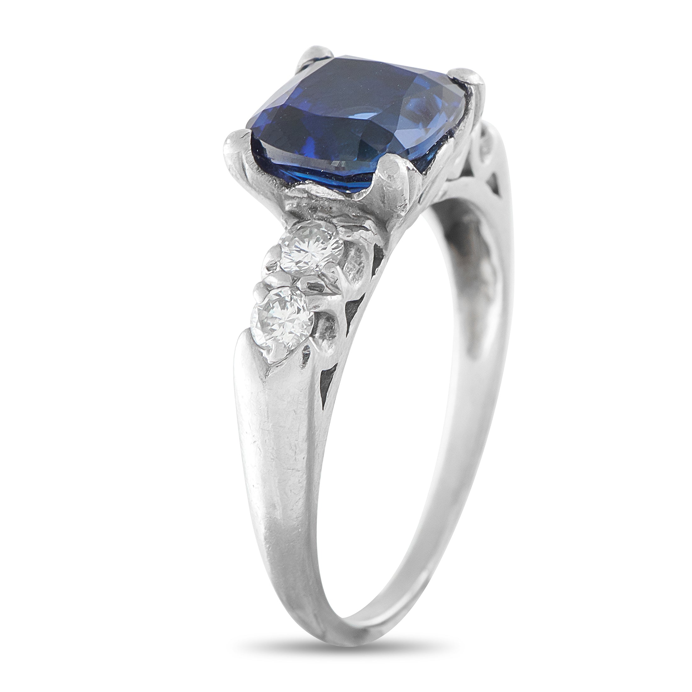 Platinum ring featuring a blue sapphire square stone with diamond side clusters