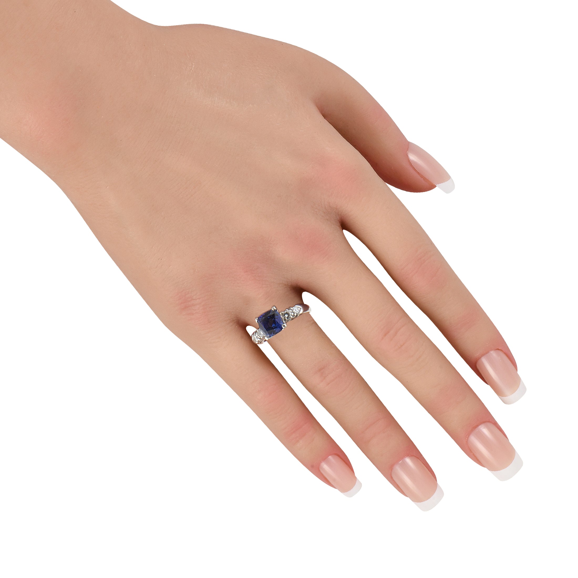 Platinum blue sapphire ring on hand with diamond band highlights