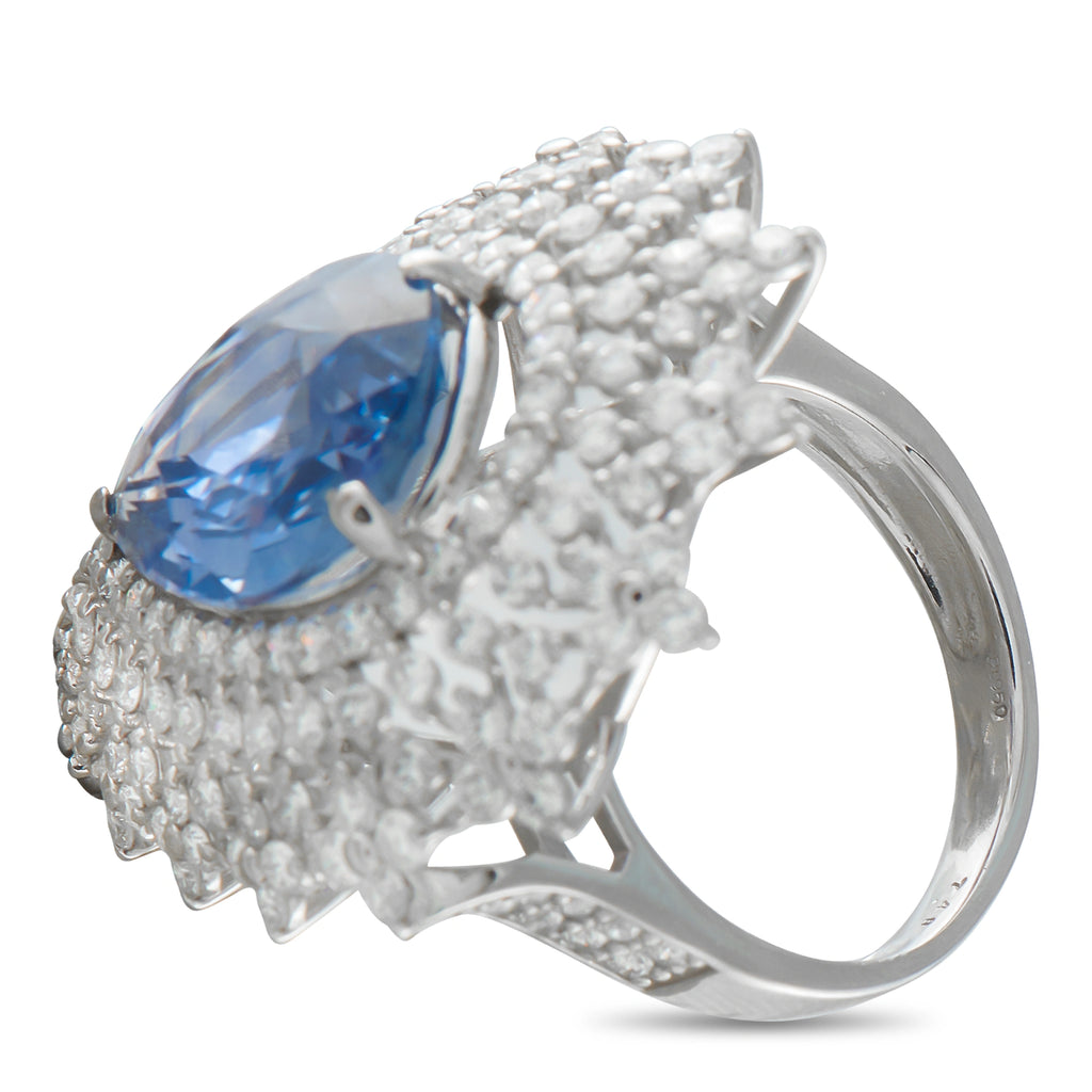 Platinum ring with pear-cut blue sapphire and diamond pavé setting