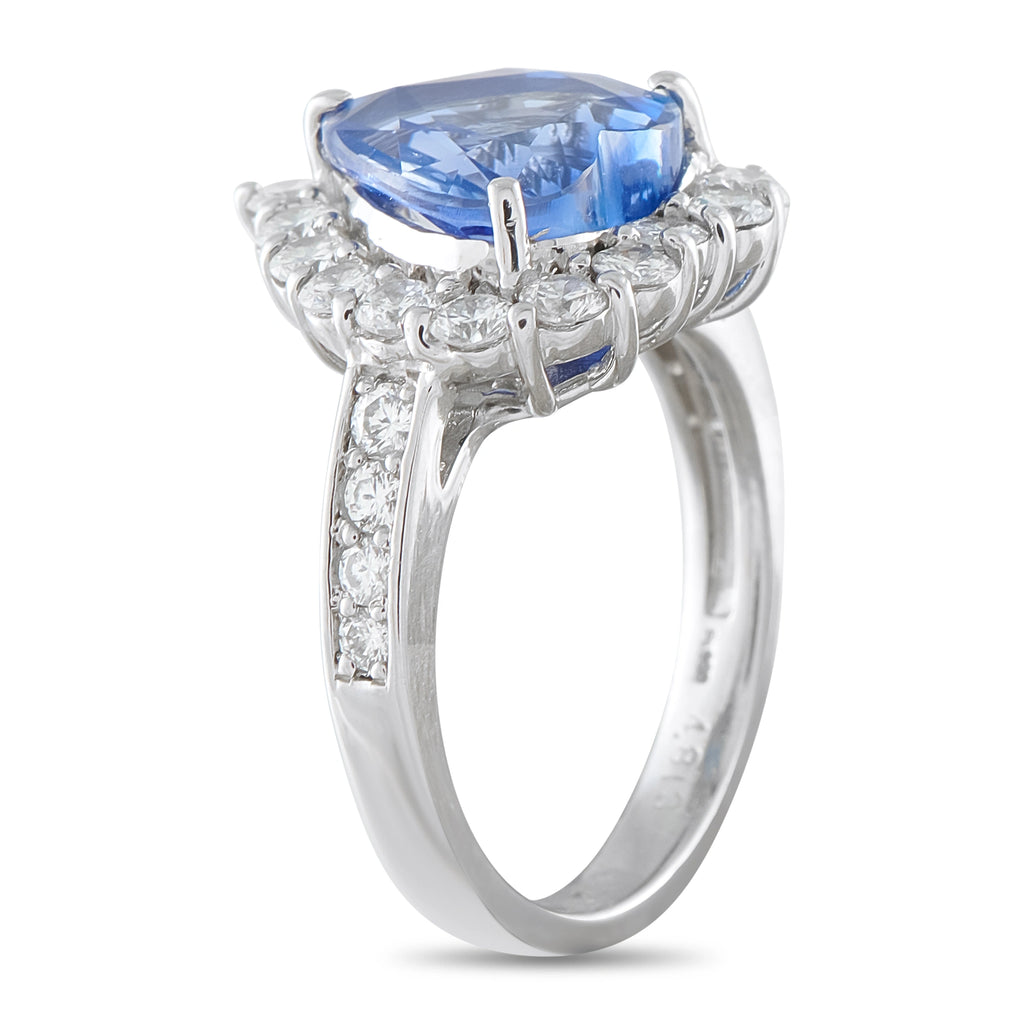 Sapphire and diamond ring shown from the side, with a platinum band and raised setting
