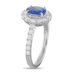 Platinum ring with oval blue sapphire haloed by diamonds and diamond band