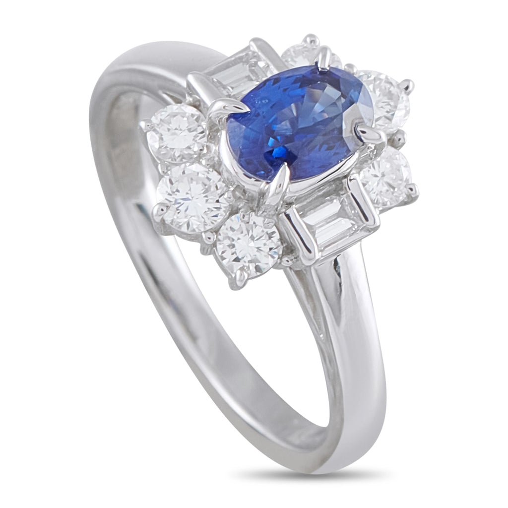 Platinum ring with oval blue sapphire center and diamond cluster, four prongs