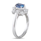 Platinum ring with oval blue sapphire and surrounding baguette diamonds, side view