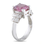 Platinum ring side view showing pink spinel, diamond accents and raised prongs