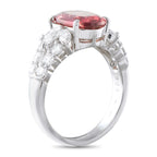 Platinum ring shown from the side, with an oval pink spinel and diamond-set shoulders