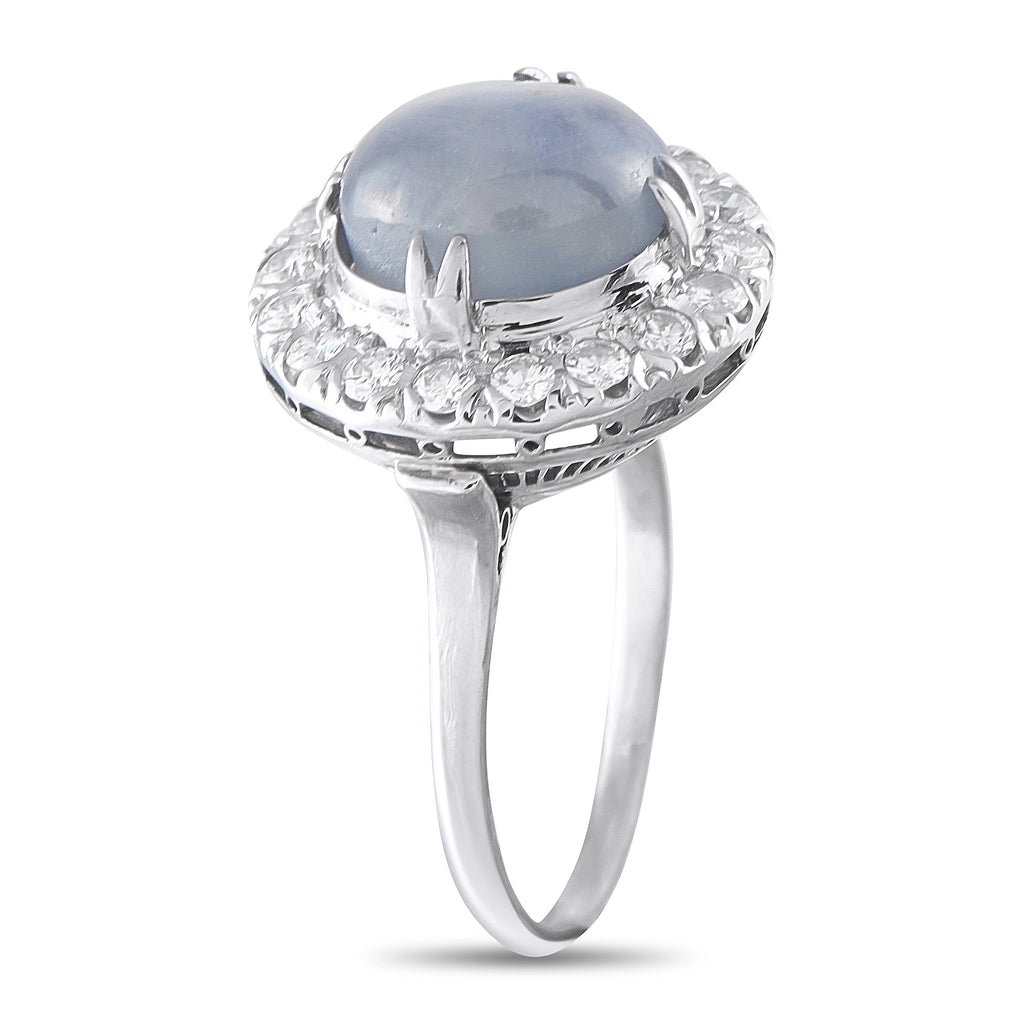 Platinum ring with round blue star sapphire top and diamond halo, side view
