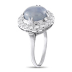 Platinum ring with round blue star sapphire top and diamond halo, side view