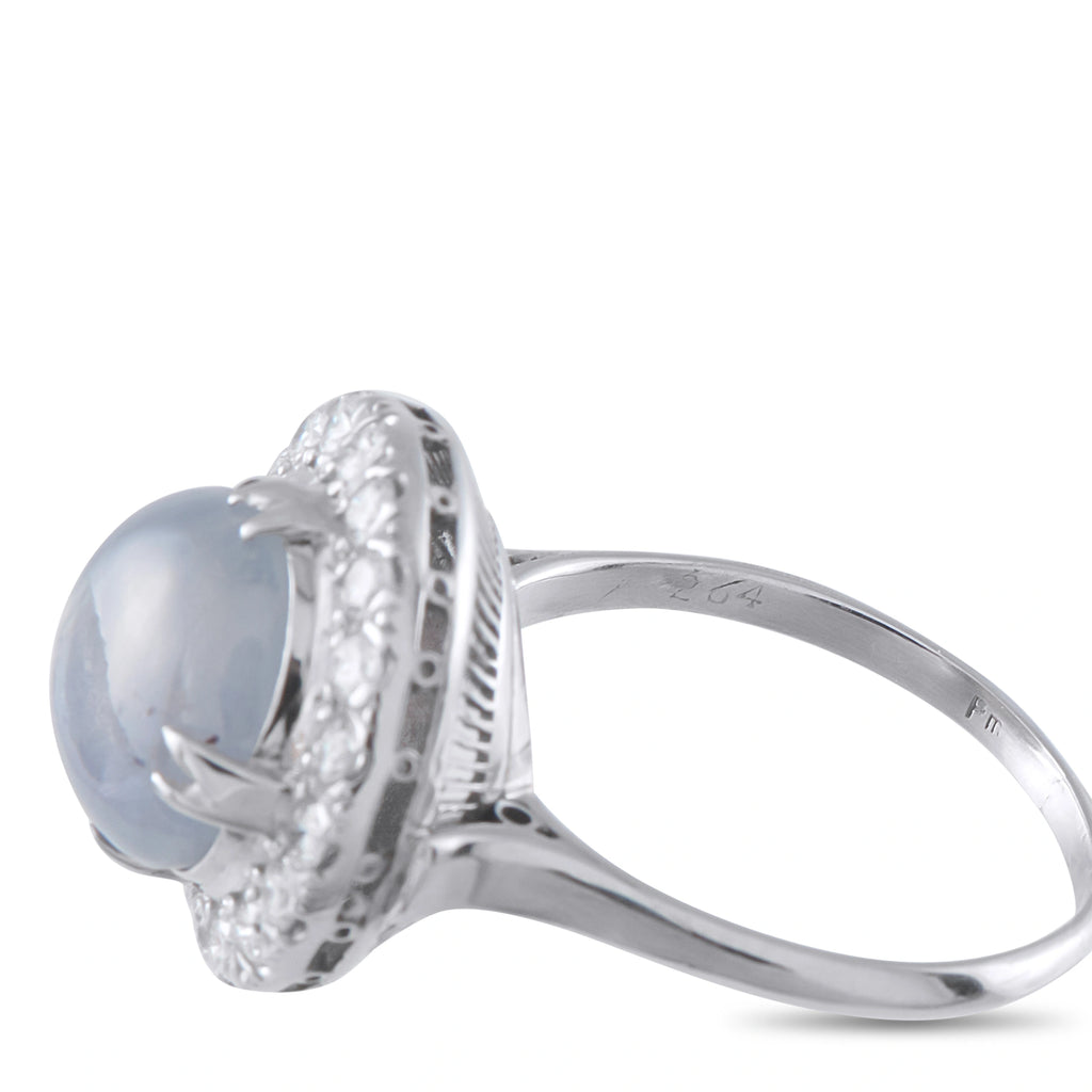 Platinum halo ring with blue star sapphire bezel and diamond halo setting, angled
