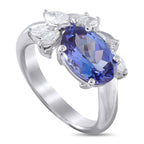 Exclusive Platinum 0.55ct Diamond and Oval Tanzanite Ring - A 2.41-carat oval tanzanite glows at the heart of this Exclusive  ring. The colored gem is gently embraced by an arc of marqu