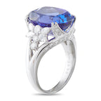 Side view of a platinum tanzanite ring with diamond clusters and a split band
