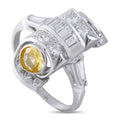 Platinum cocktail ring with oval yellow sapphire and diamond halo accents