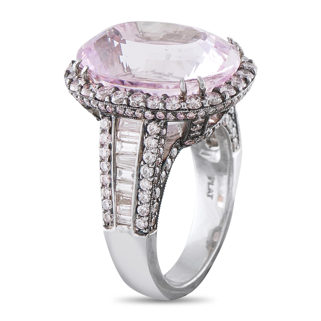 Platinum ring featuring oval pink center stone, round diamonds, and baguette accents