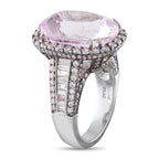 Platinum ring featuring oval pink center stone, round diamonds, and baguette accents