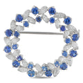 Round brooch with blue sapphire and diamond-like stones, silver-toned setting
