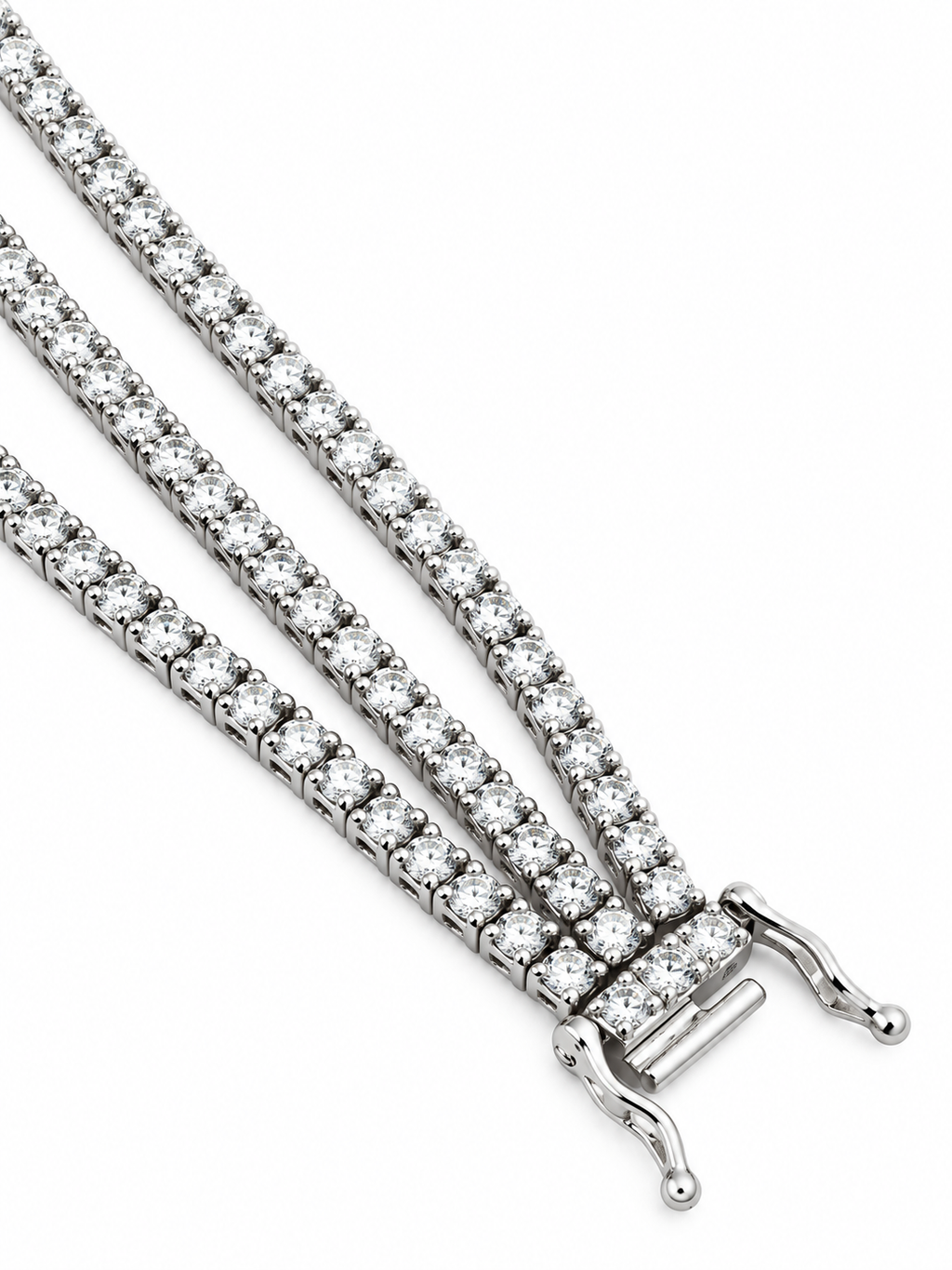 Close-up of triple-row diamond bracelet with white gold fold-over clasp ends.