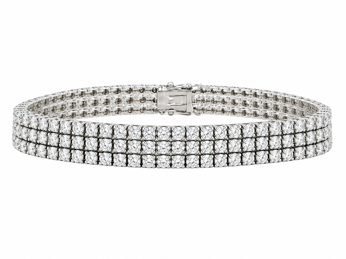 White gold tennis bracelet with three diamond rows and a fold-over clasp.