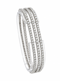 Triple-row diamond bracelet in white gold with hinged oval bangle profile.