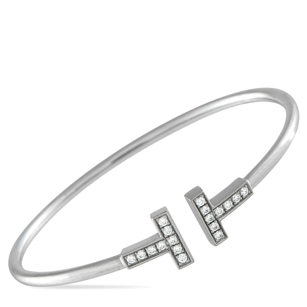 Tiffany & Co.Tiffany & Co. 18K White Gold Diamond T Bracelet - Modern and sophisticated, this Tiffany & Co. T Wire Bracelet pays homage to the luxury brand’s enduring legacy. At each end o