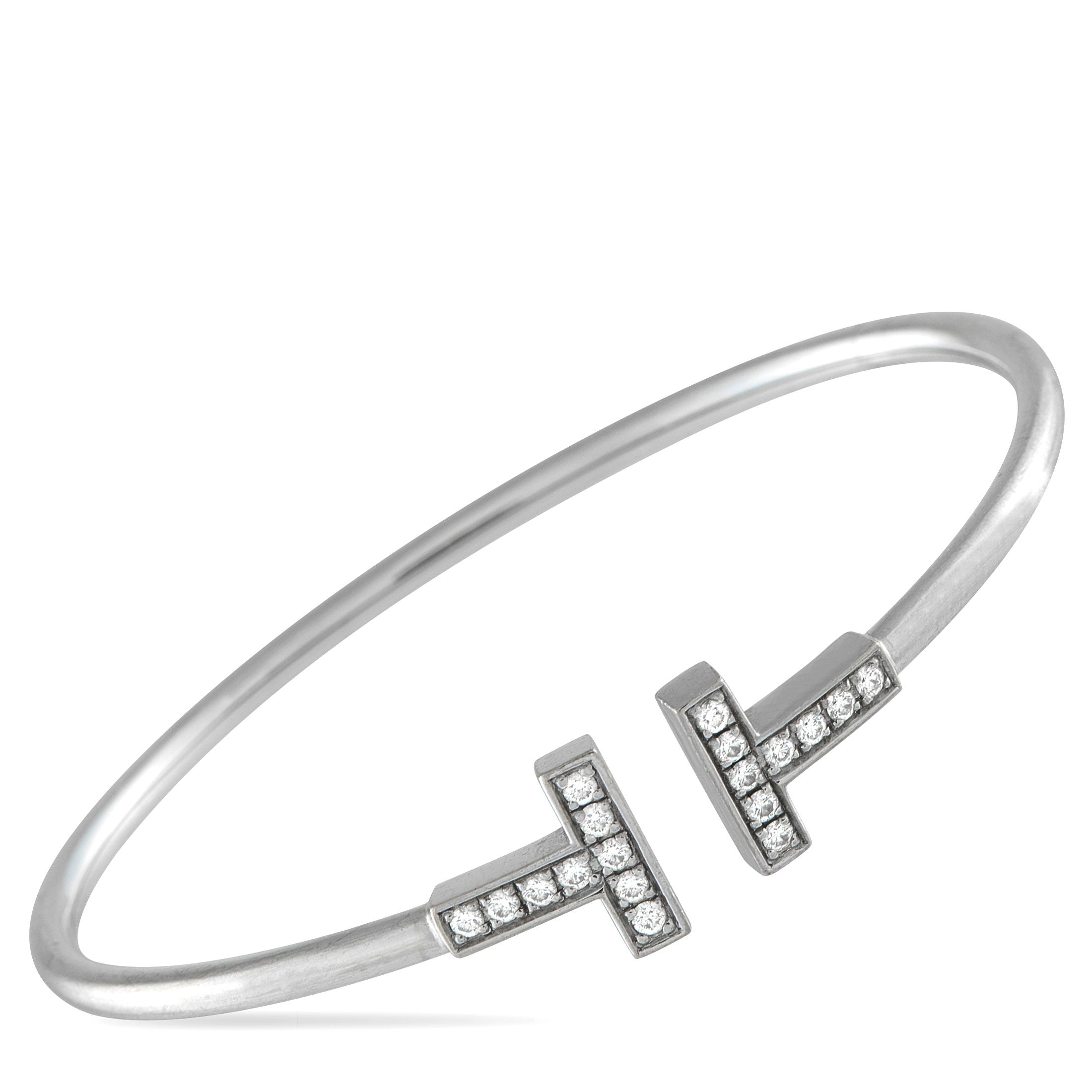 Tiffany & Co.Tiffany & Co. 18K White Gold Diamond T Bracelet - Modern and sophisticated, this Tiffany & Co. T Wire Bracelet pays homage to the luxury brand’s enduring legacy. At each end o