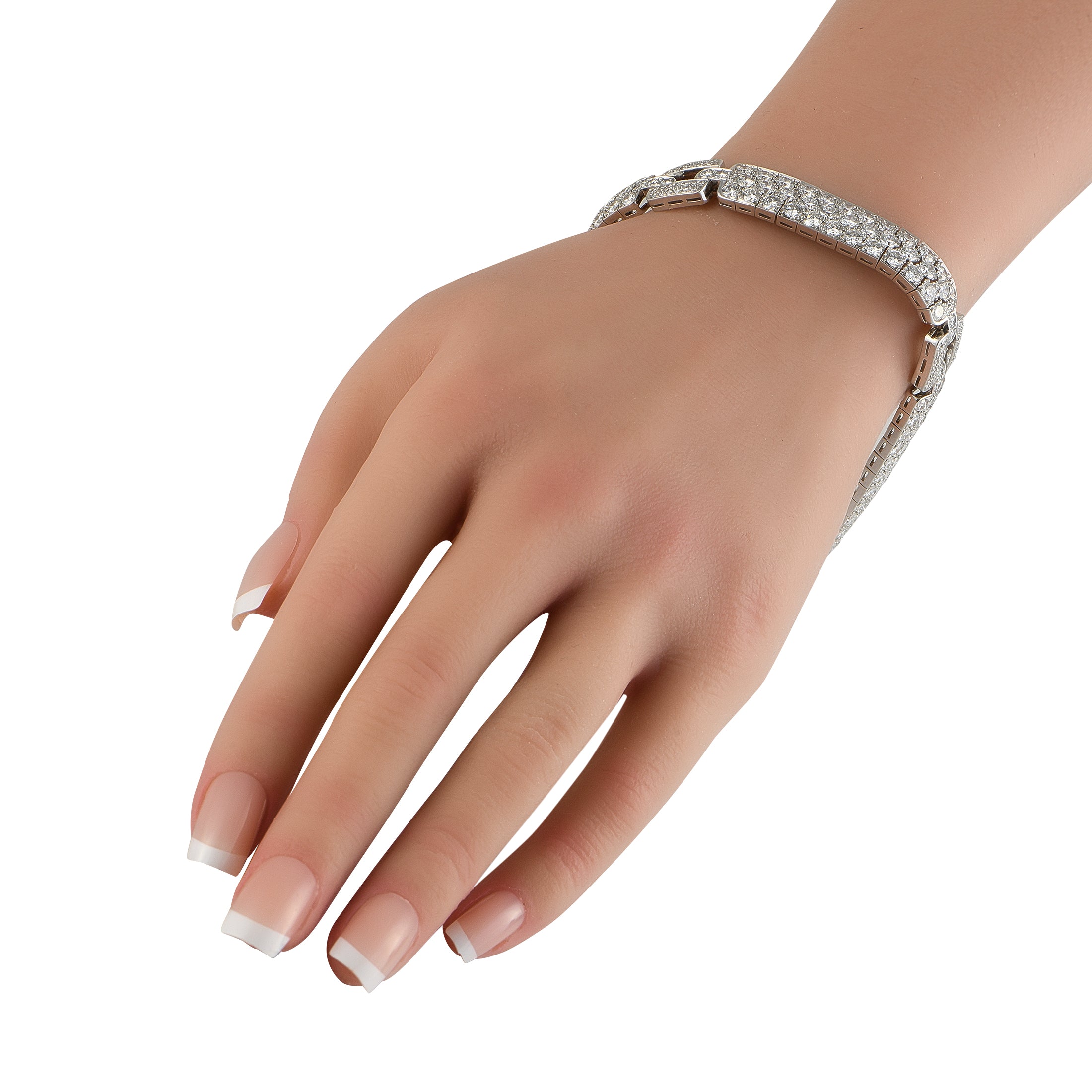 Platinum diamond tennis bracelet on wrist with round stone row