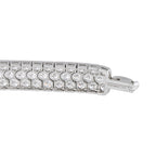 Engraved platinum diamond tennis bracelet with round stone row and clasp detail