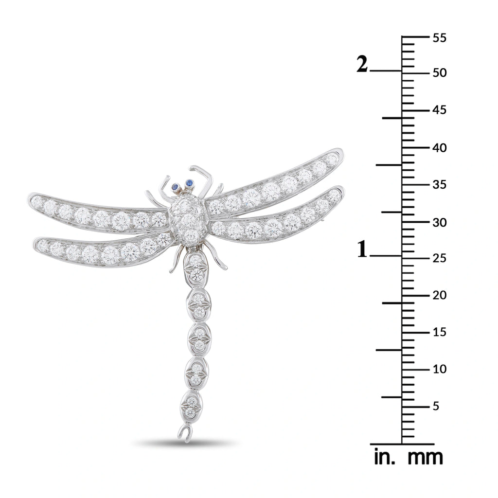 Platinum diamond dragonfly brooch with blue eye accent shown next to size scale in mm