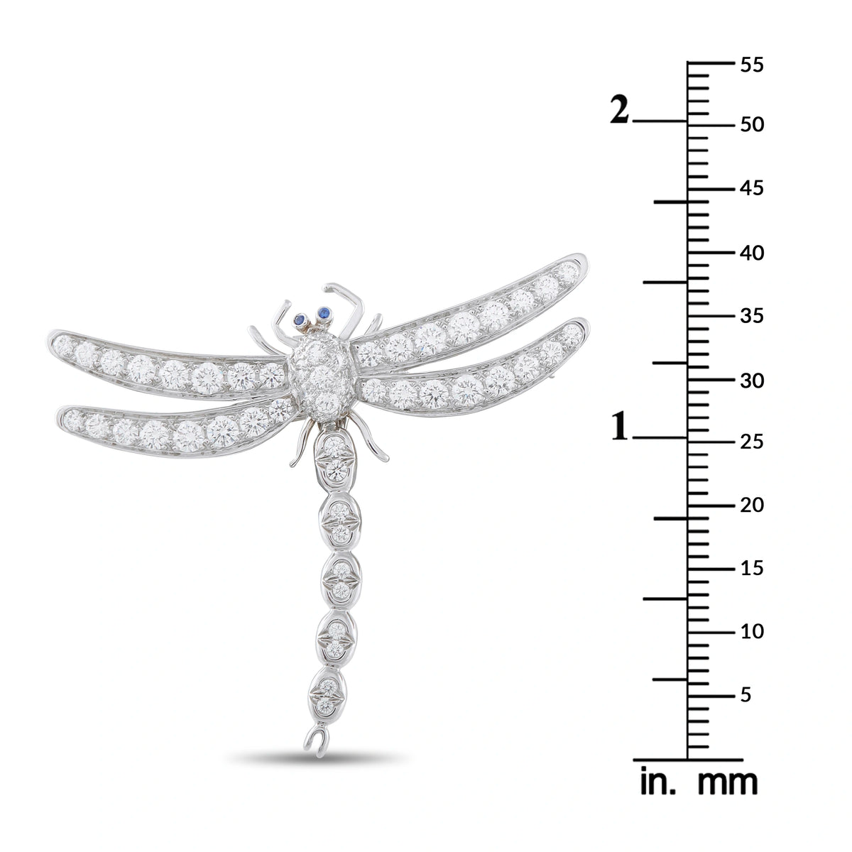 Platinum diamond dragonfly brooch with blue eye accent shown next to size scale in mm
