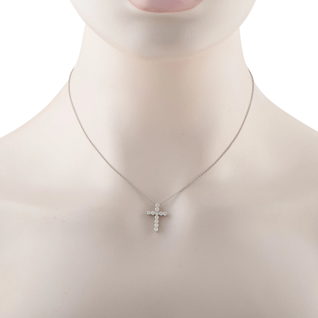 Platinum diamond cross pendant on thin chain, small clustered stone design