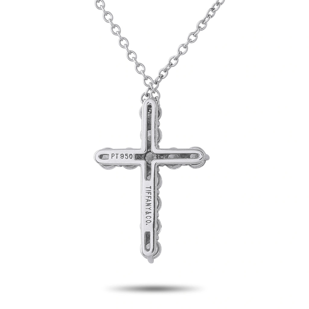 Platinum diamond cross pendant with engraved detailing and stone border
