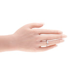 Tiffany & Co. platinum diamond ring worn on a finger, with a three-stone setting