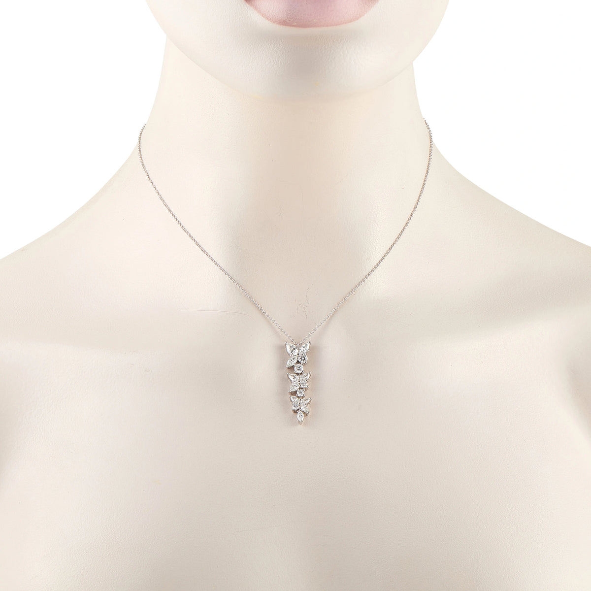 Tiffany & Co. Victoria diamond necklace worn on a display bust, showing its petite floral pendant
