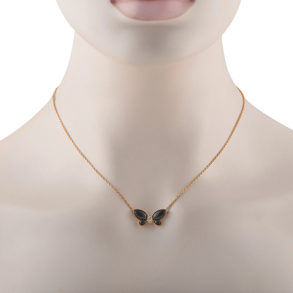 Butterfly onyx pendant on 18K yellow gold chain worn on neck