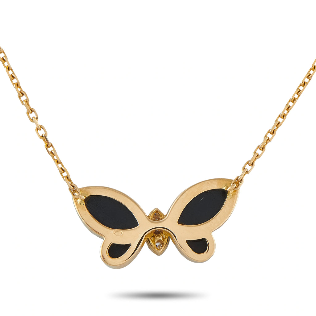 Yellow gold butterfly pendant with dark onyx wings and diamond accent, on chain