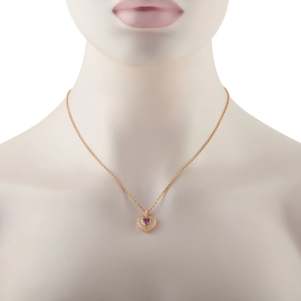 Yellow gold heart pendant with pink sapphire center and diamond pave on mannequin neck