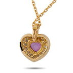 Yellow gold heart pendant with pink sapphire center and diamond details on chain