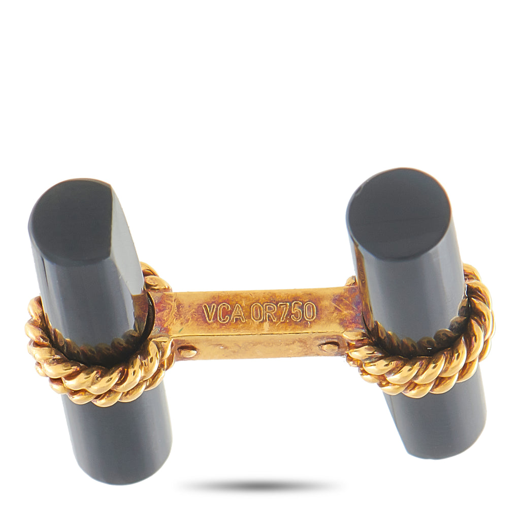Cufflinks close-up: dark onyx ends with engraved gold bar and gold chain detail