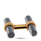 Cufflinks underside view: dark onyx cylinders with gold bar and chain links
