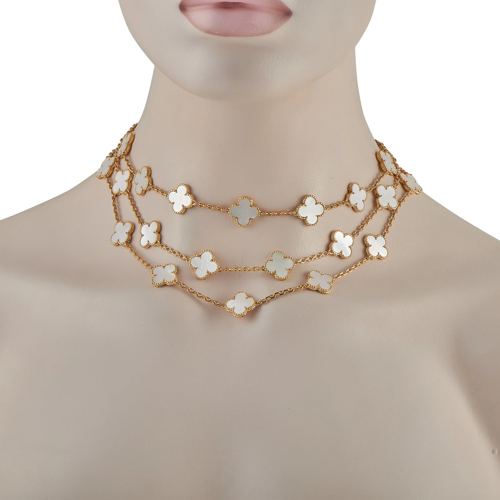 18K yellow gold clover necklace with mother-of-pearl motifs worn at neckline