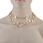 18K yellow gold clover necklace with mother-of-pearl motifs worn at neckline