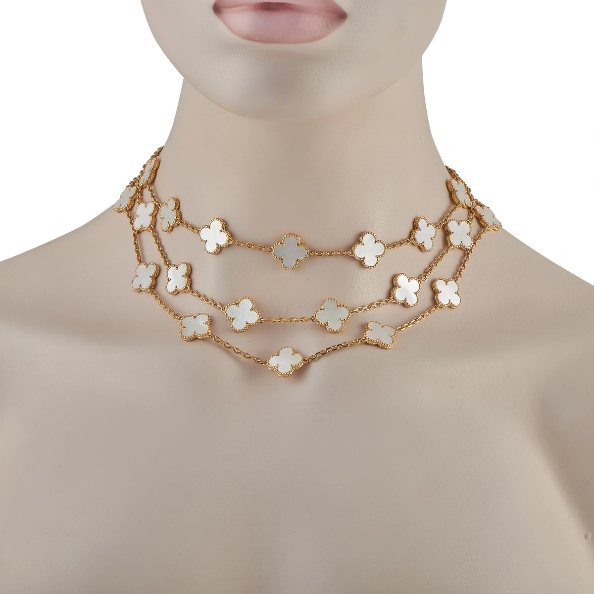 18K yellow gold clover necklace with mother-of-pearl motifs worn at neckline