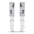 Dangling white gold earrings with four-petal motifs, onyx accents, and pearly drops