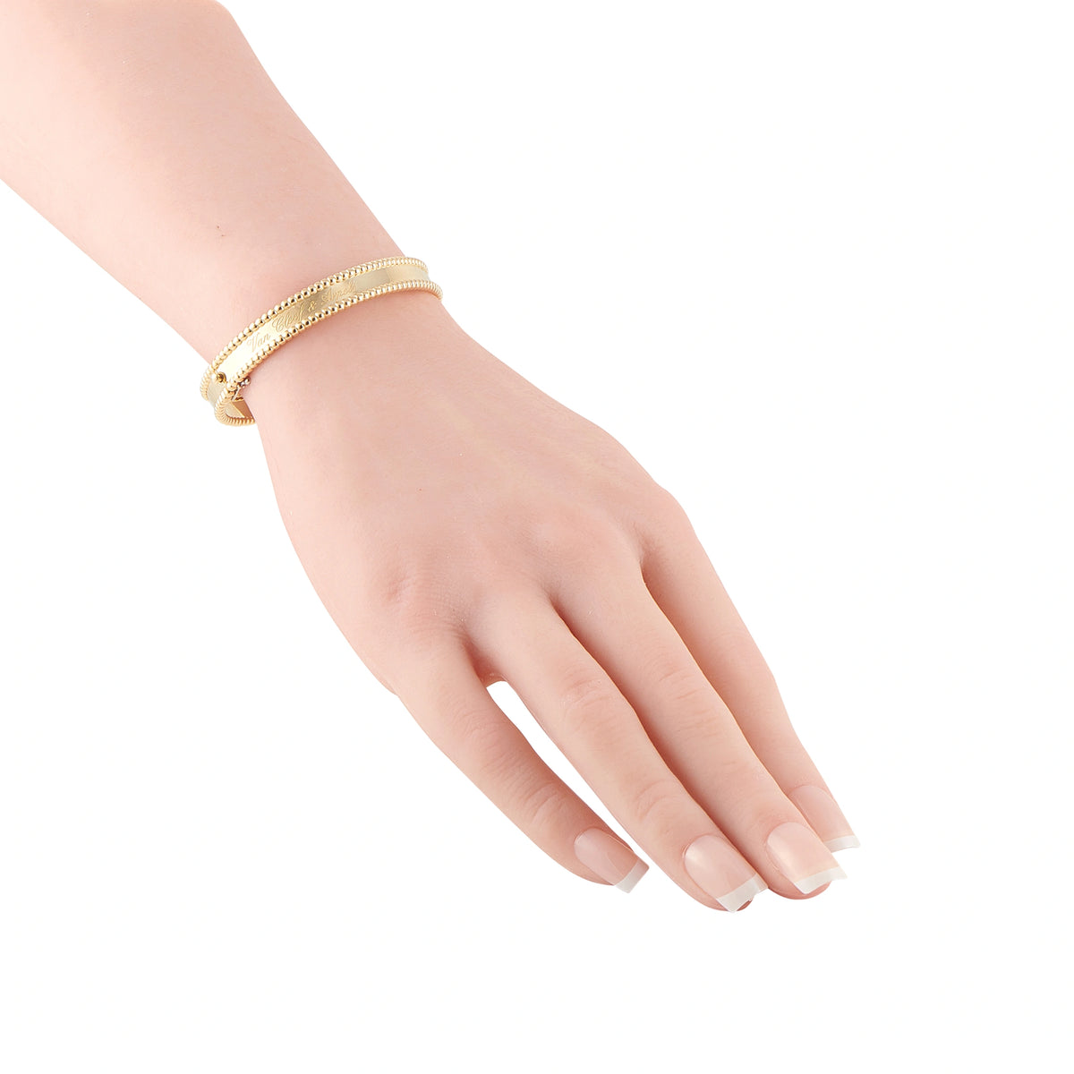 Yellow gold beaded bangle worn on the wrist