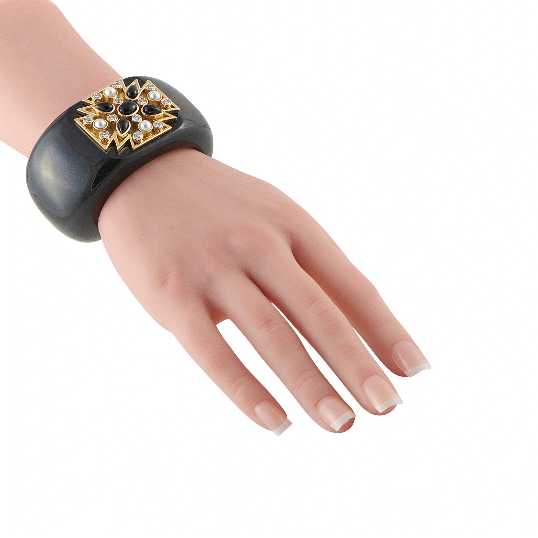 Black cuff bracelet on wrist, Maltese cross centerpiece with gold and white stones