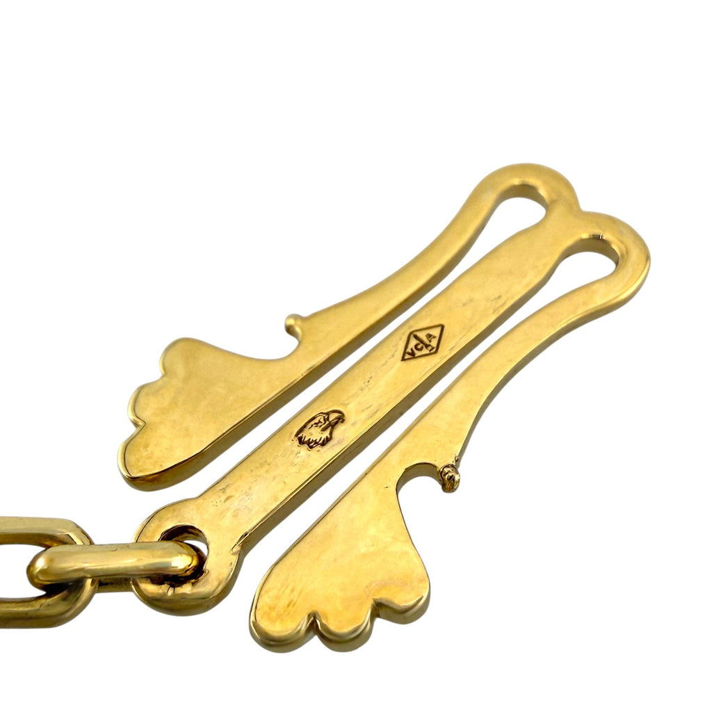 18k gold clasp detail with engraved emblem and hinge design on necklace hardware