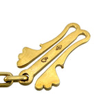 18k gold clasp detail with engraved emblem and hinge design on necklace hardware