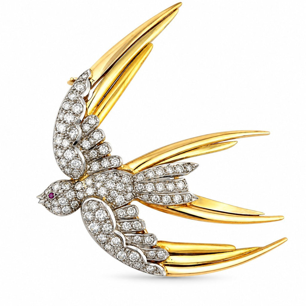 Diamond and ruby bird in flight brooch in yellow and rose gold