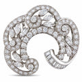 18K white gold diamond swirl brooch with round and pear stones, hinged pin.