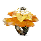 Gold and amber floral ring with pearl-like center, sparkling stones, and dark base