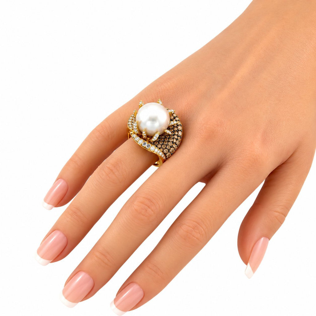 18K yellow gold ring with pearl and champagne diamonds on a hand